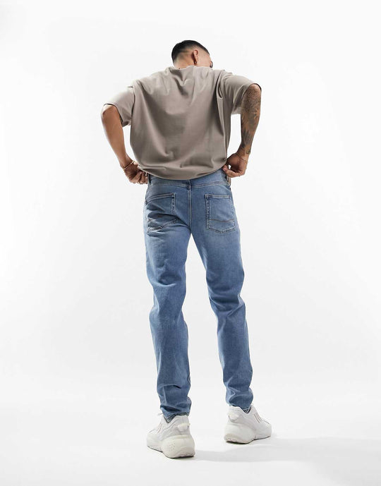 ASOS Design Stretch Tapered Jeans in Vintage Light Wash Blue