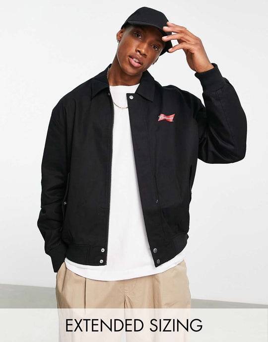 ASOS Design Oversized Varsity Jacket with Budweiser Print in Black