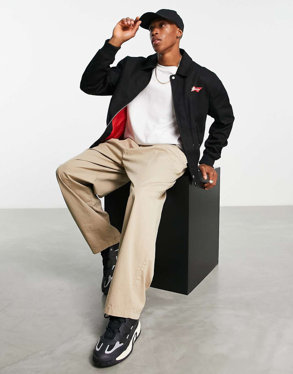 ASOS Design Oversized Varsity Jacket with Budweiser Print in Black