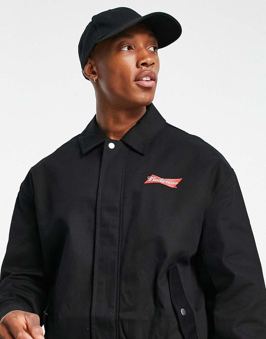 ASOS Design Oversized Varsity Jacket with Budweiser Print in Black